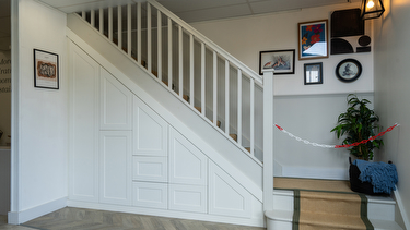 White shaker style understairs storage