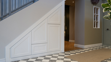 White shaker style understairs storage