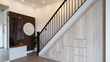Contemporary light driftwood understairs storage