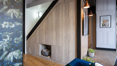 Contemporary light wood understairs storage